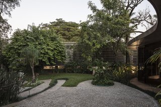 A Modern Concrete Retreat by Oscar Niemeyer Is Available For the First Time - Photo 6 of 6 - The home embraces its natural surroundings; most areas, including the main living space, open to the lush garden behind the property that was designed by the legendary Brazilian modernist landscaper, Roberto Burle Marx. 