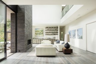 The bright and airy open living room features a double-height ceiling.