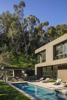 The pool area also features an outdoor kitchen and ample space for entertaining.
