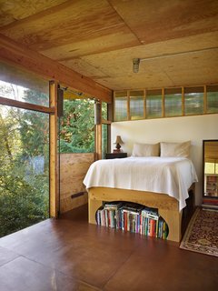 Reclaimed Materials Make Up This Artist Studio in Washington - Photo 4 of 6 - A door next to the bed drops down, opening the room to its environs. Hoover has said that her favorite aspect of the house is its calm mood and "the quietude and solace I experience while inside." 
