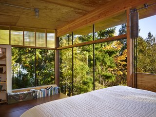 Reclaimed Materials Make Up This Artist Studio in Washington - Photo 5 of 6 - In the sleeping loft, floor-to-ceiling windows overlook a canopy of trees.
