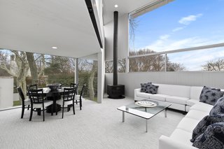 The open-plan living and dining space features large windows on all sides—the bright spacious interiors are a testament to Gwathmey's visionary talent.