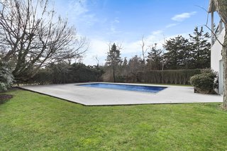 The pool and expansive lawn provide ample space for outdoor entertaining. 
