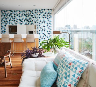 Also adorned with bright colorful tiles, the enclosed terrace now features a bar and a relaxing den-like nook that can be partitioned off with curtains. 