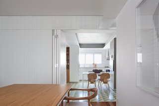 A hinged door can conceal the kitchen to create a more formal dining space. 