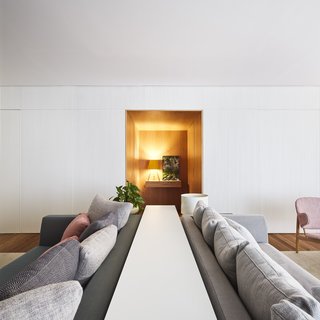 Two sofas have been placed back-to-back to create separate social spaces in the home. 