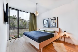 Own This Alluring Sculptural Abode in Austin For $3.1M - Photo 8 of 21 - A peek at another bright and minimalist bedroom. 