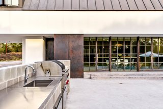 Own This Alluring Sculptural Abode in Austin For $3.1M - Photo 18 of 21 - The pool area even features an outdoor kitchen. 