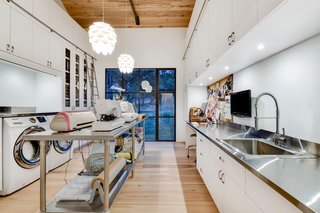 Own This Alluring Sculptural Abode in Austin For $3.1M - Photo 11 of 21 - For instance, this huge utility room could do double-duty as a craft room.