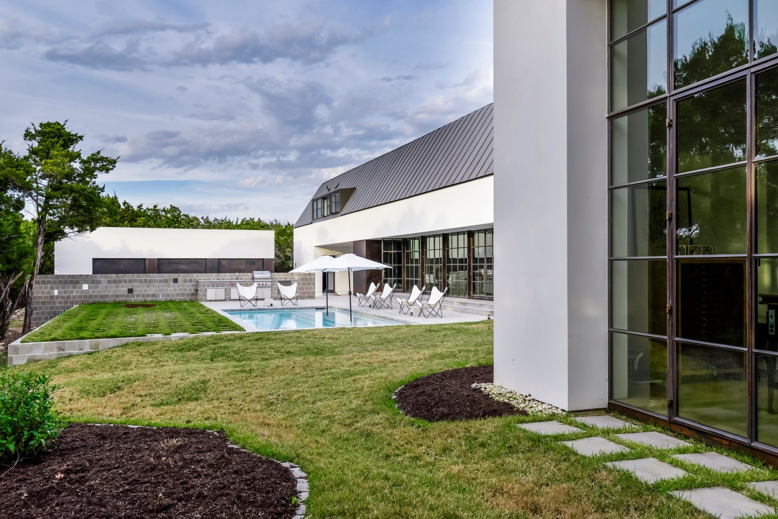 An extension of the living space is an outdoor pool and lawn.