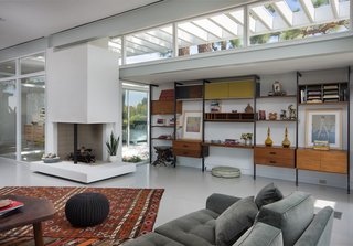 Rooney Mara Asks $3.45M For a Restored Midcentury Stunner in L.A. - Photo 3 of 8 - The open-plan living room is anchored by a wood-burning, two-sided fireplace. 