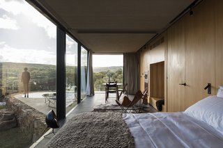 A New Prefab Hotel in Uruguay Seems to Melt Into the Landscape - Photo 4 of 9 - The sleek, modern interiors feature minimalist furnishings, dark stone floors, and light oak walls.