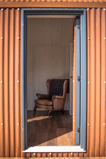 Go Off-Grid in This Prefabricated Cor-Ten Steel Cabin - Photo 7 of 12 - The entrance to the minimalist cabin. 