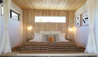 After: Wood paneling and a platform bed was a perfect solution for fitting a king-size bed into a small space.