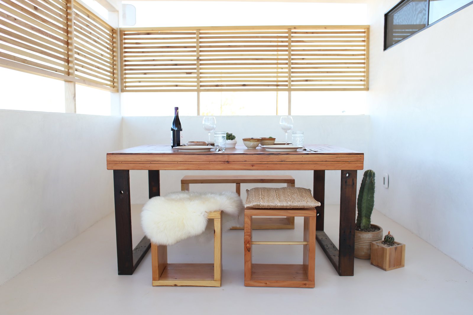 A porch enclosed with a screen to increase light and air-flow became a dining area.
