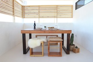 A covered patio which is used as a dining area was enclosed with a horizontal wood screen to create a sense privacy. The other end of the patio was left open to make the most of the expansive desert view. 