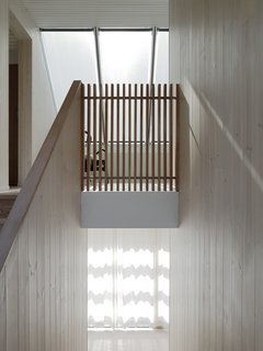 Large windows and skylights provide ample natural light, which is reflected off the larch interiors and white ceilings.