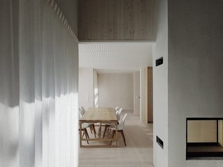The dine-in kitchen and living area are divided by a double-sided fireplace and chimney. 