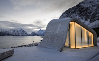 This Concrete Rest Stop Will Make You Want to Visit Norway - Photo 7 of 8 - The wave-shaped structure appears to glows from within thanks to its translucent glazing.