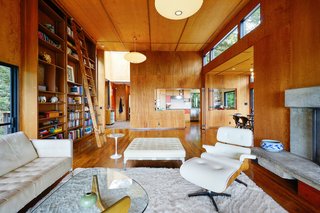This Knockout Midcentury in the Bay Area Will Run You $1.9M - Photo 4 of 16 - The living room boasts original, wood-paneled ceiling and walls and beautiful built-in bookshelves.