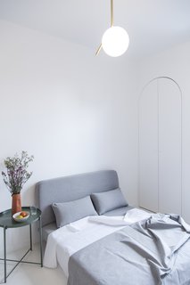 The sofa is the most conventional space-saving feature, as it easily unfolds into a bed. The arched closet houses the washer/dryer. 