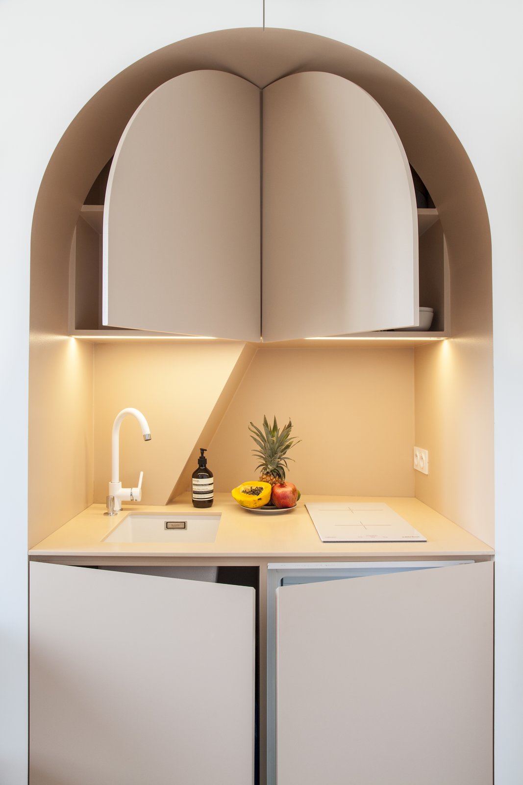 Pop-out doors reveal storage space and a tiny refrigerator.