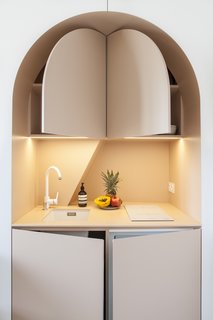 Pop-out doors not only reveal storage space, but also a tiny refrigerator, and microwave. 