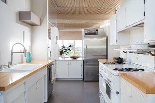 The simple, updated kitchen is opposite the dining area. 