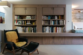A cozy den with a built-in sitting area is off the dining room. 