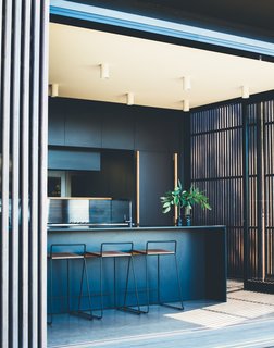 The building is kept low to the ground, so you can step directly from the house into the garden.