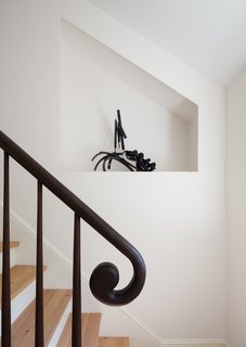 Yun designed this curved handrail. To the side, a carved niche is meant to showcase art.