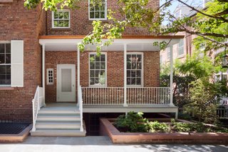 The deck was done in a madras gray limestone so that the color matches the backyard steps of the other houses. The railings were based on the metalwork of the other nine house.