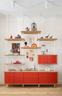 The red wall cabinet was designed by August. The floors throughout the home were replaced with wide, salvaged heart pine floorboards with radiant heat. 