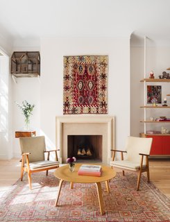 Now virtually unrecognizable, the parlor floor is the home's open-plan living area. A formerly defunct fireplace was reactivated and clad with a custom-made, limestone mantle. 