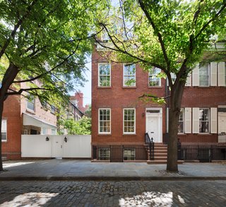 YUN Architecture carefully restored the exterior of the house with new windows, dormers, and wood frames.