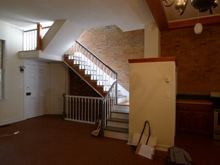 The biggest architectural maneuver in the renovation was moving the staircase to allow for a more spacious kitchen. In this view, you can see the little volume at the center that housed the refrigerator. 