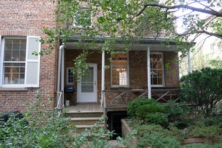 The wooden porch in the rear yard was deemed illegal during the Department of Buildings process. Wood is not allowed, and it had to be remade with non-combustible materials. 