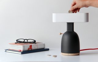 Currently, the Dina is just a prototype—the body and shade are made with a 3D printer, and the top and bottom lids are made from natural ash wood. The interior features a mechanism that holds the coins and turns the light on by closing the electrical circuit.