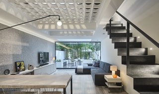 Thanks to the glass perforations connecting the first two levels of the home, the structure no longer suffers from a dark, gloomy interior. The team also incorporated a handmade steel staircase to link the ground floor to the basement.
