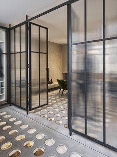 The glass partition doors assist in opening the space up, while also enhancing the natural light.<br>