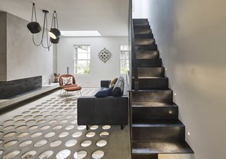 On the first floor, solid steel plates transform into a perforated metal spine, which cuts right through the building to the top floor. 