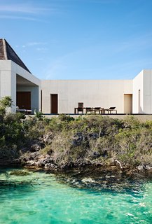 The dining area opens to the pool which overlooks the expansive ocean. 