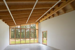 Inside the structure, wall space is prioritized with concealed plywood blocking to support hanging work. 