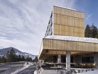 The individual modules are emphasized by metal siding; the rest of the building has been constructed from vertical slats of rough-cut, untreated larch. 