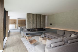 Neutral, earthy tones and a mix of materials give the living room a warm and cozy vibe.