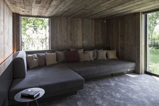 The garden's former wartime bunker has been connected to the property and transformed into a cozy, wood-clad media room.