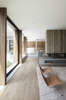 The two-sided fireplace separates the dining room and the living room. 