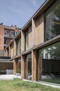Timber, glass, and concrete compose the simple exterior of the structure. 