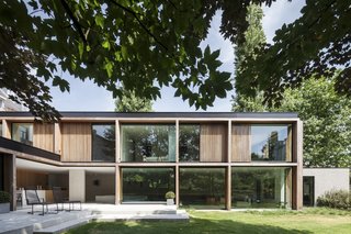 The ground floor follows an L-shaped plan and is accessed from the garden via a concrete terrace. 