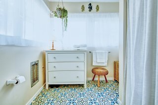 Bright, graphic floor tiles have also been used in the bathroom. 